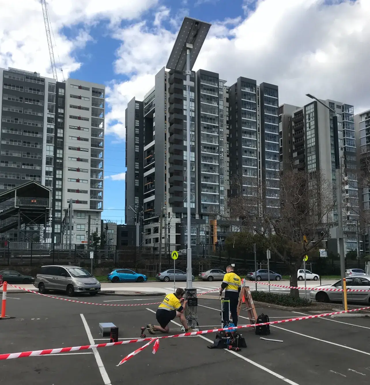 Empire electricians servicing a solar street light near Sydney apartments